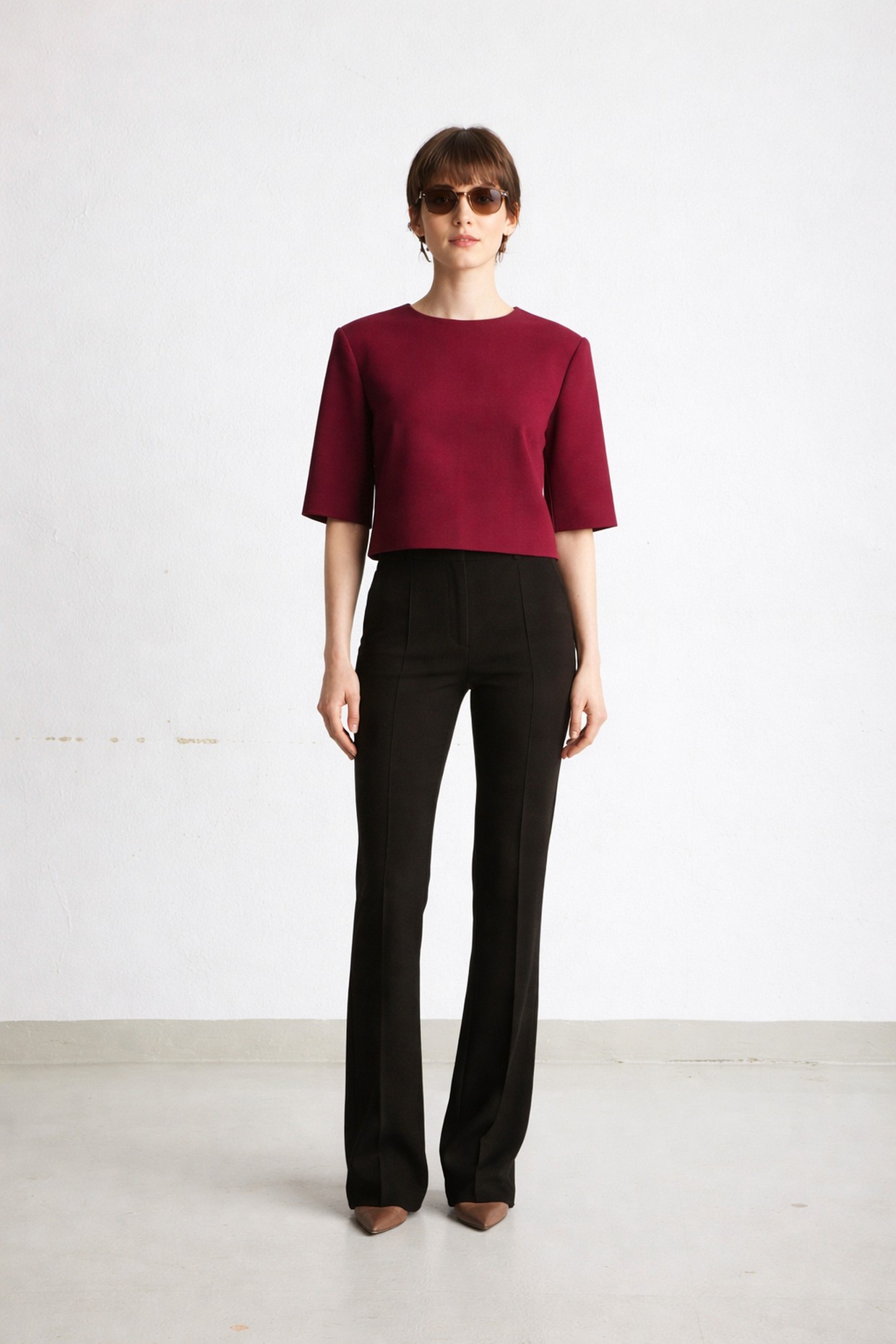 Short burgundy boxy T-shirt with shoulder pads.